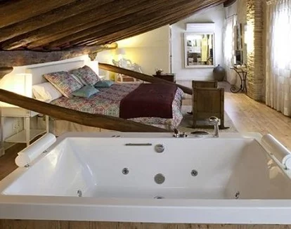 Foto de la suite con jacuzzi junto a la cama en el Casa Rural Lakoak