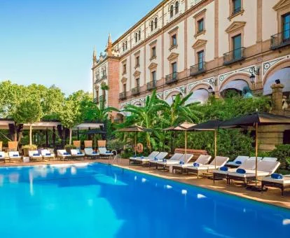 Hotel con encanto con piscina exterior rodeada de vegetación.