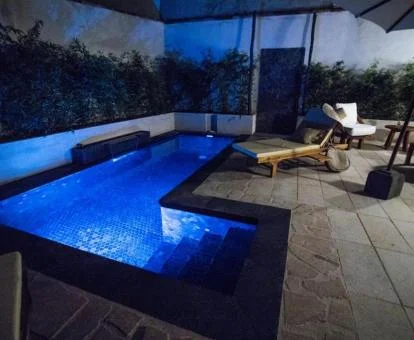 Zona exterior con piscina al aire libre y solarium de este hotel romántico.