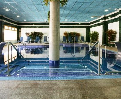 Piscina cubierta con elementos de hidroterapia del spa del hotel.