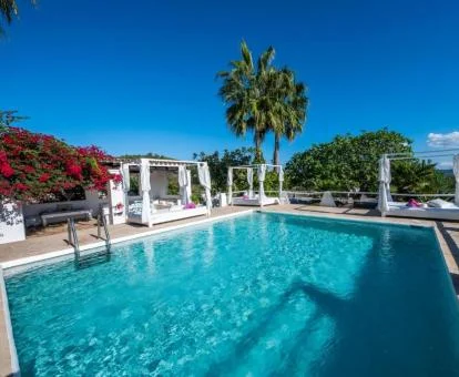 Agradable zona exterior con piscina y solarium rodeada de vegetación de este hotel rural.