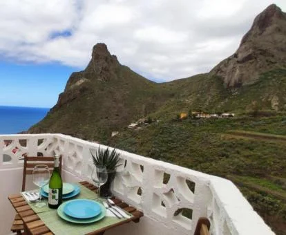 Terraza con comedor y vistas al mar y a las montañas de esta casa rural.
