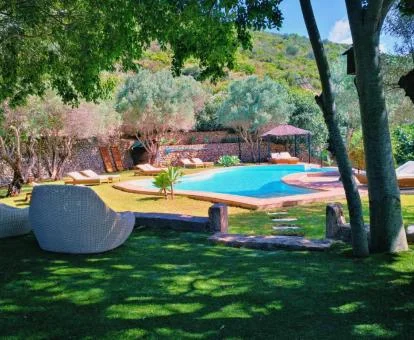 Agradable zona exterior con piscina y vegetación de este hotel rural.