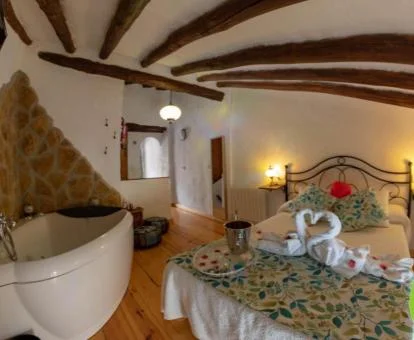 Dormitorio con jacuzzi cerca de la cama de una de las casas de un dormitorio del establecimiento.