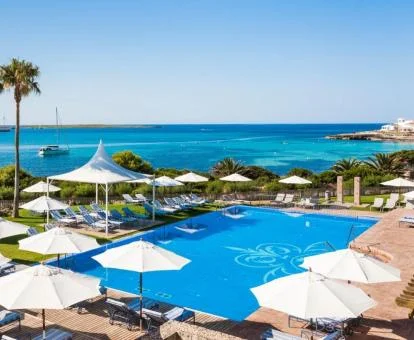 Exteriores de este hotel con encanto con amplios jardines, piscina y vistas al mar.