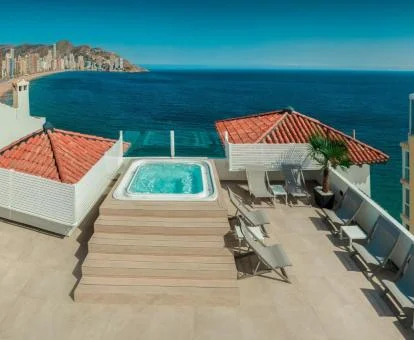 Agradable terraza solarium con jacuzzi y vistas al mar del hotel.