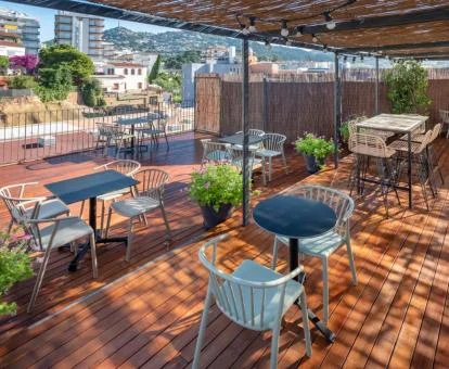 Acogedora terraza con mobiliario exterior y vistas a la ciudad de este hotel solo para adultos.