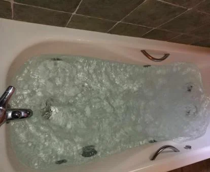 Bañera de hidromasaje privada en el baño de uno de los apartamentos de un dormitorio.