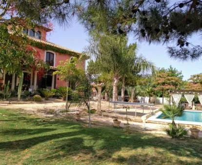 Alojamiento rural con piscina exterior y zona ajardinada.