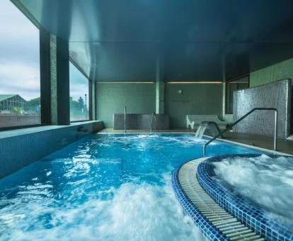 Piscina cubierta con elementos de hidroterapia y fabulosas vistas de este hotel.