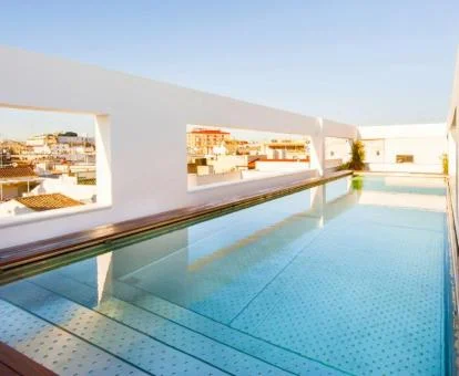 Moderna piscina en la terraza de este hotel con vistas a la ciudad.