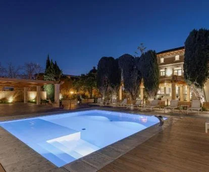 Edificio con iluminación nocturna de este bello hotel boutique con piscina y zonas exteriores.