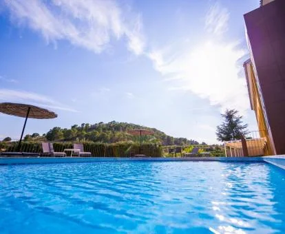 Amplia piscina con vistas a la naturaleza de este hotel con encanto.