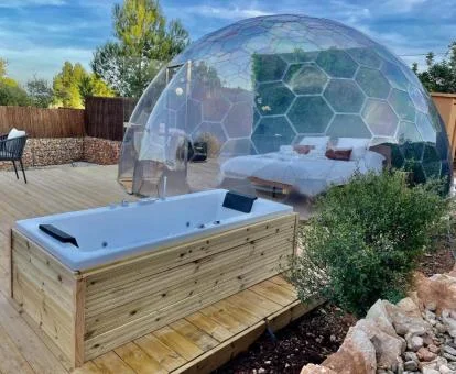 Preciosa habitación burbuja de este establecimiento con zona exterior y jacuzzi.