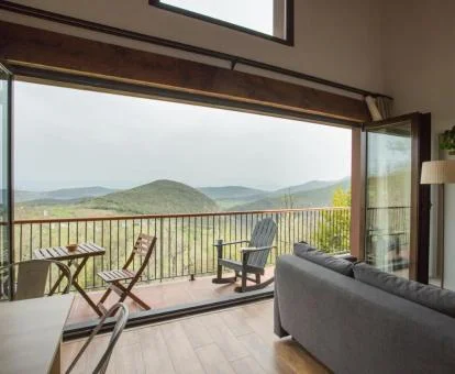 Sala de estar con amplios ventanales que dan acceso a una terraza con fabulosas vistas a la naturaleza.