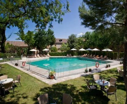 Amplia piscina rodeada de jardines y vegetación de este bonito parador.