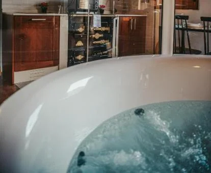 Bañera de hidromasaje privada del apartamento deluxe con cama doble.