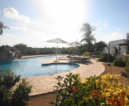 Agroturismo con piscina exterior rodeada de jardines.