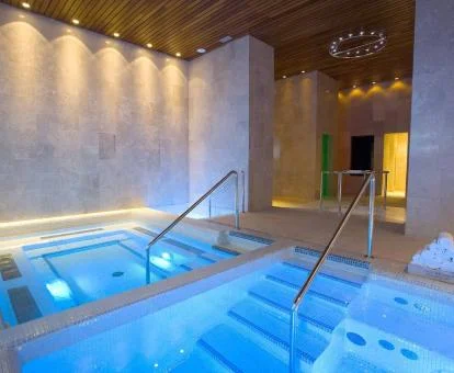 Piscina cubierta con elementos de hidroterapia del spa del hotel.