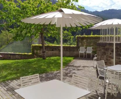 Zona exterior ajardinada con mobiliario exterior y preciosas vistas de este hotel solo para adultos.