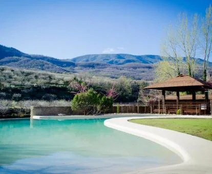 Zona exterior con piscina y bellos jardines de este hotel con encanto.