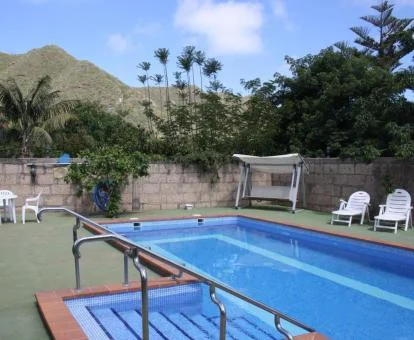 Zona exterior con piscina y mobiliario de este establecimiento rural.